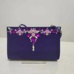 Clutch pesta lipit mata warna ungu dengan ornamen permata dan payet bunga bagian depan Za'Nis Bag