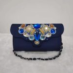 Tas pesta wanita Ovalebag warna biru navy dengan hiasan ornamen permata dan tali rantai Za'Nis Bag